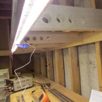 The temporary LED strip mounted up on the benchwork with a clamp.