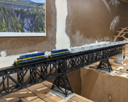 The first test train - a short empty ore train headed north - crosses the span.