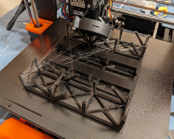 Here's a set of halves being printed.  Yes, I have a bit of a stringing problem on these.